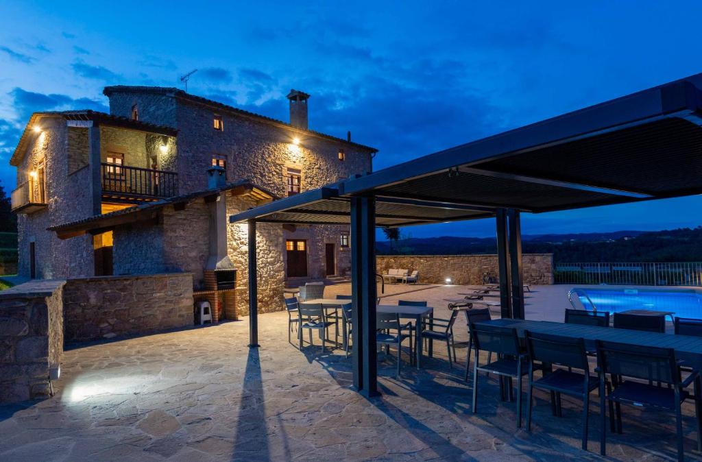 a patio with tables and chairs in front of a building at Masia Lledó de Trascastell in Balsareny