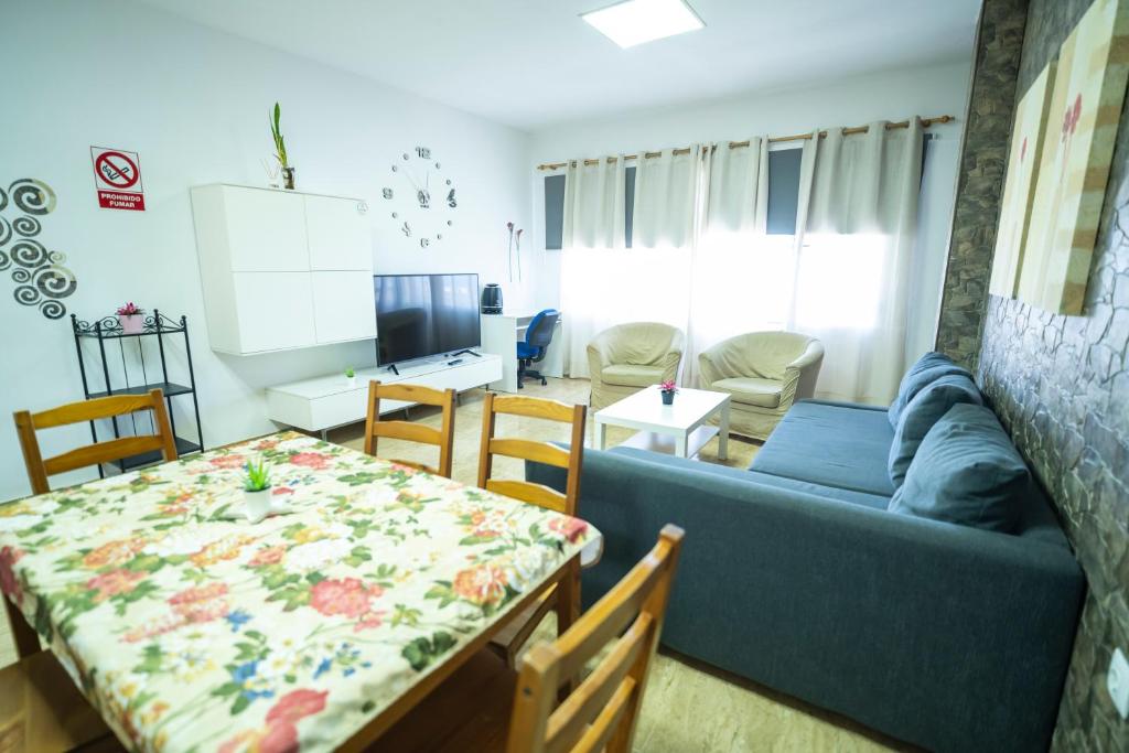 a living room with a blue couch and a table at Edificio Prieto VIV 2E in Puerto del Rosario