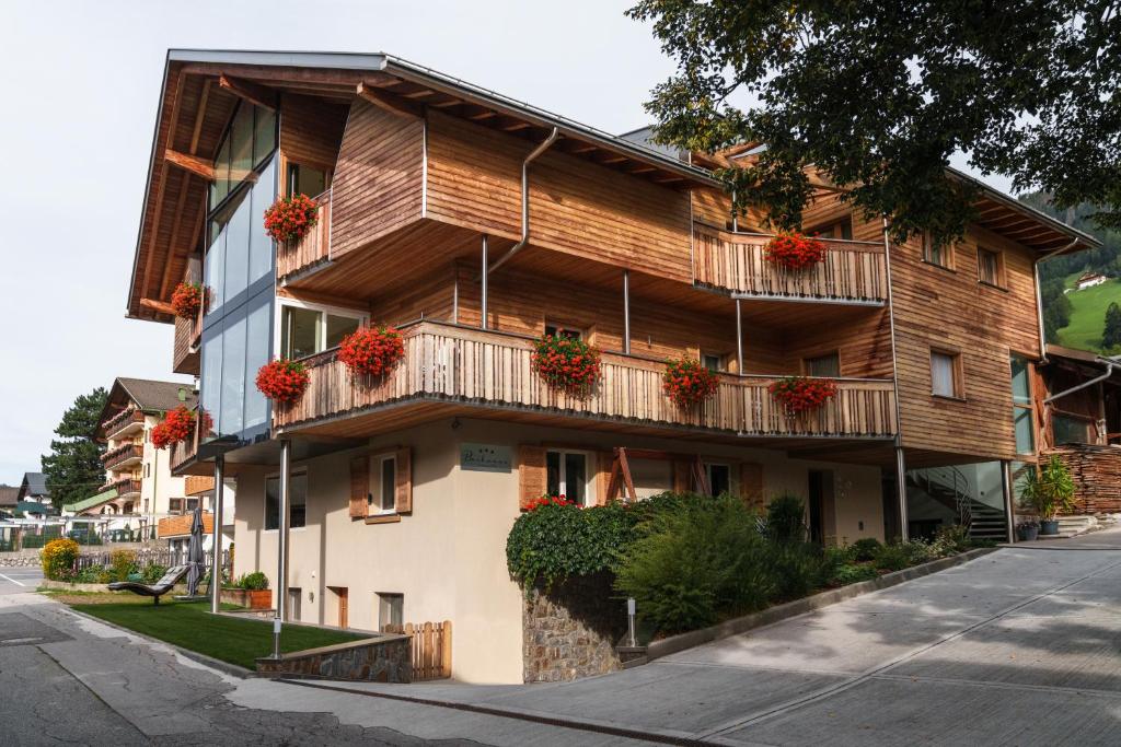 a building with flower boxes on the balconies at Apartments Bachmann in San Candido