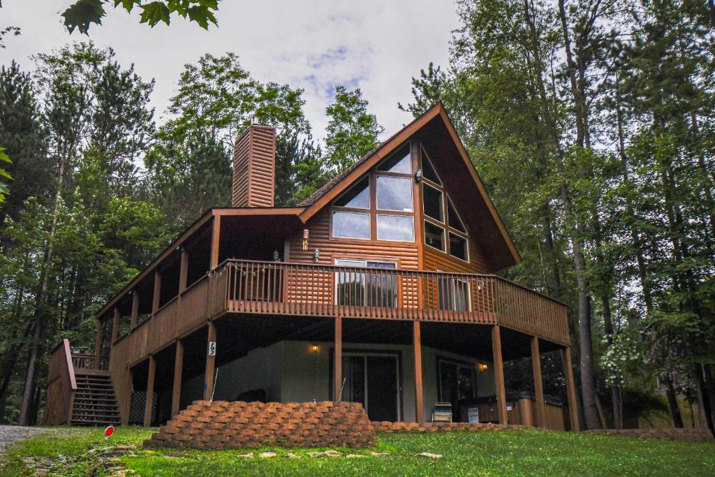 a house with a wrap around porch and a balcony at Howling Wolf Den in Oakland