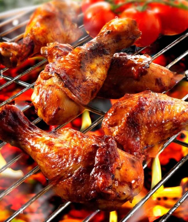 a group of chicken wings and tomatoes on a grill at Lulu s dream cafe in Welata