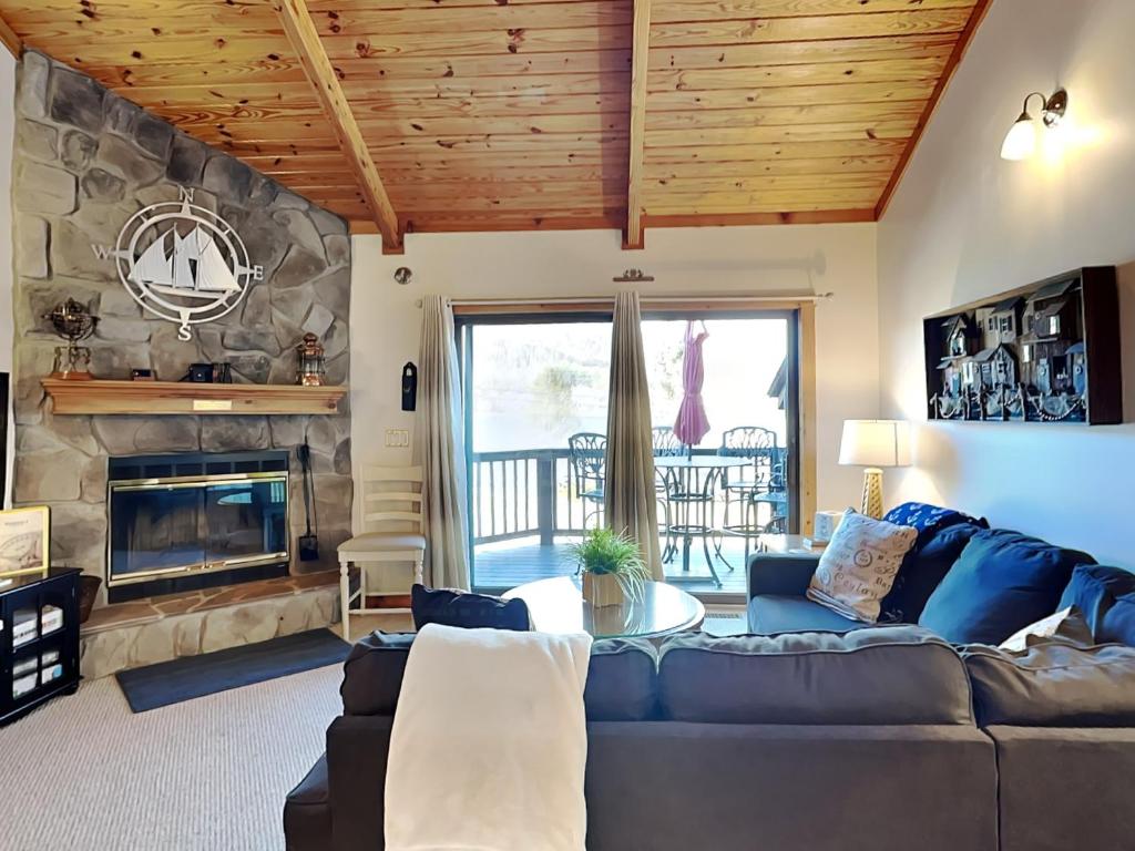 a living room with a couch and a fireplace at Sunplace 02 in McHenry