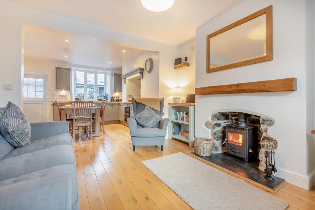 a living room with a couch and a fireplace at 2 Bed in Sticklepath oc-l33312 in Sticklepath