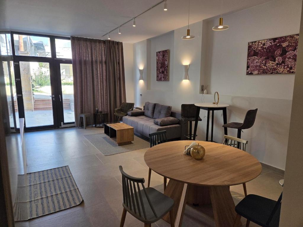 a living room with a table and a couch at Karatza's suite 2 in Chios