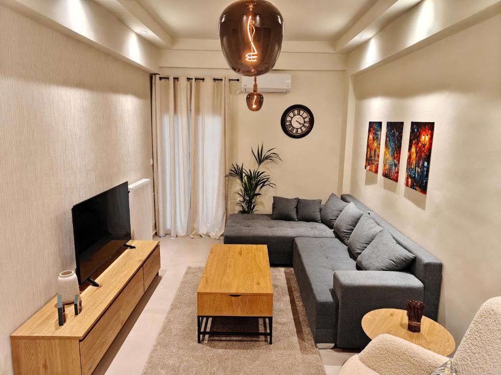 a living room with a couch and a tv at Your Inn in Tríkala