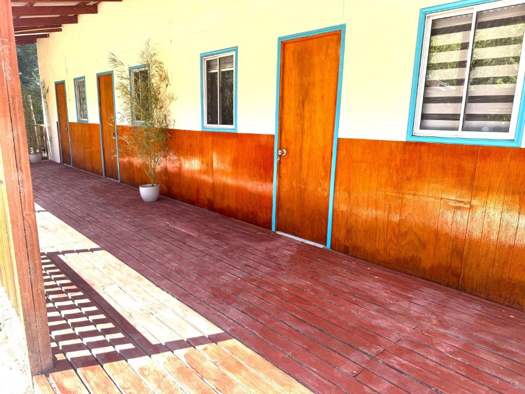 a row of wooden doors on a building at Agro Camping Los Costeños in Choapa