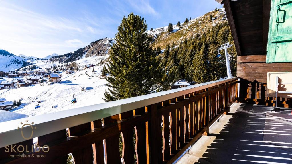 a balcony of a house with a snow covered mountain at Haus Chämihitta, Riederalp Moosfluh in Riederalp