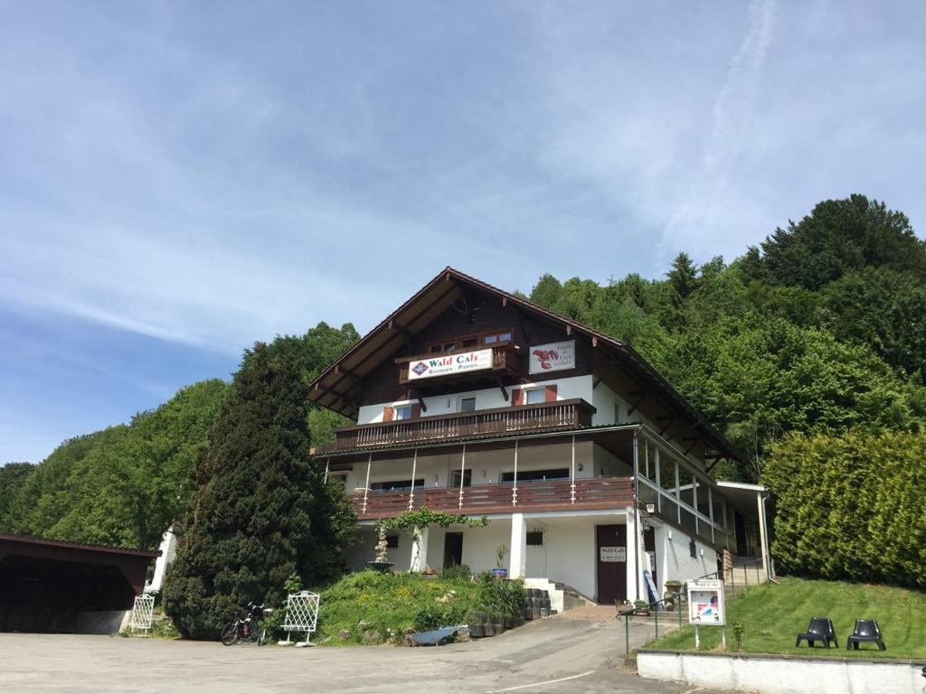 a building with a sign on the side of it at Wald Cafe in Simbach am Inn