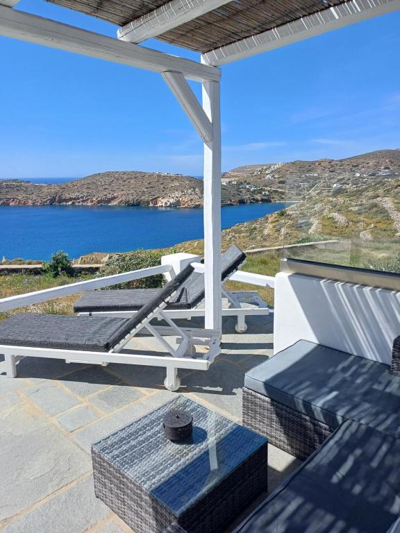 a patio with a view of a body of water at Romantic House Sea View Adults only in Ios Chora
