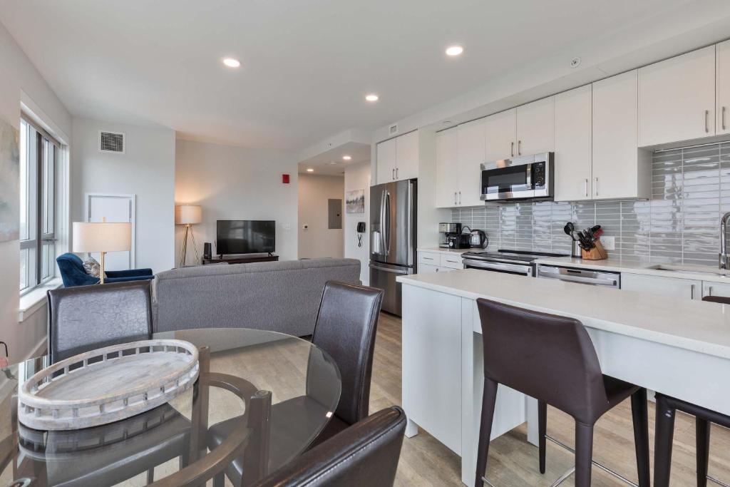 a kitchen and living room with a table and chairs at Spacious Apt Downtown in Quincy