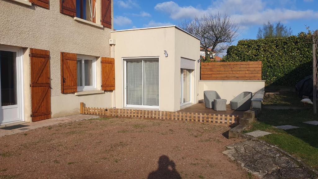 a shadow of a person standing in front of a house at le pied des monts in Sainte-Consorce