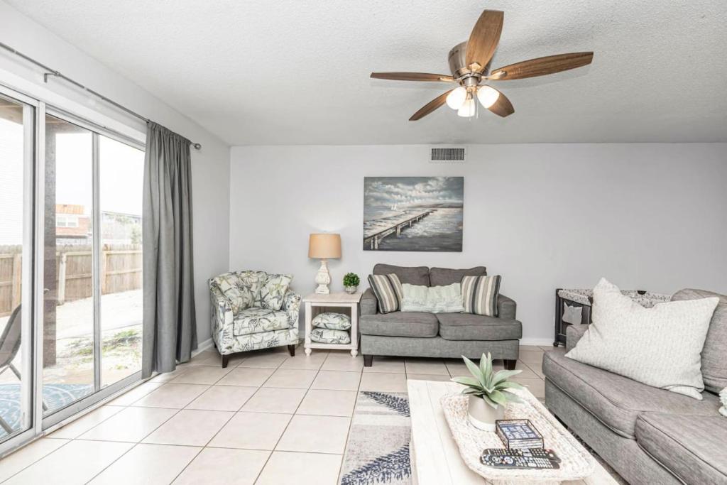 a living room with a couch and a ceiling fan at Islandwood in Fort Walton Beach