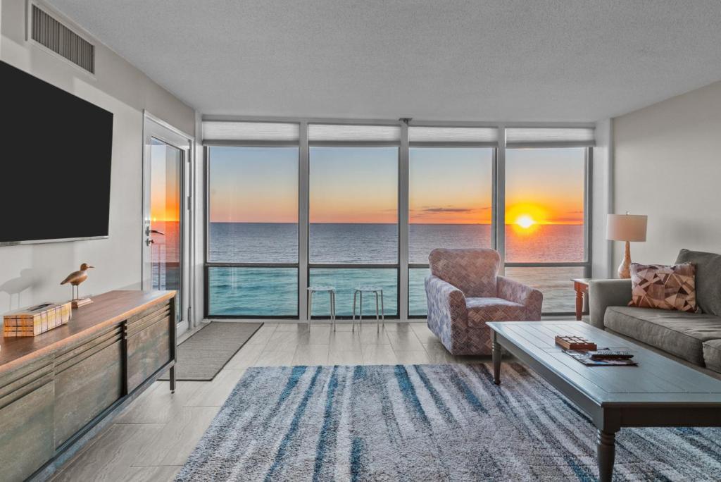 a living room with a view of the ocean at Oceanfront Condo/ Pool/ Surfing/ Fishing / EW 1002 in Virginia Beach
