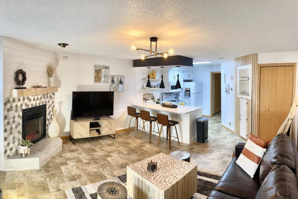 a living room with a couch and a fireplace at The Wanderlust at the Sunset Cove in Wisconsin Dells