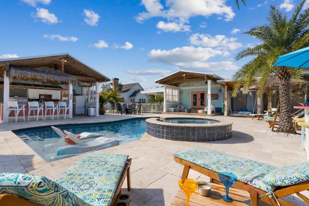 a patio with chairs and a swimming pool at The Anchor Once Upon A Tide Villas POOL in Bay Saint Louis