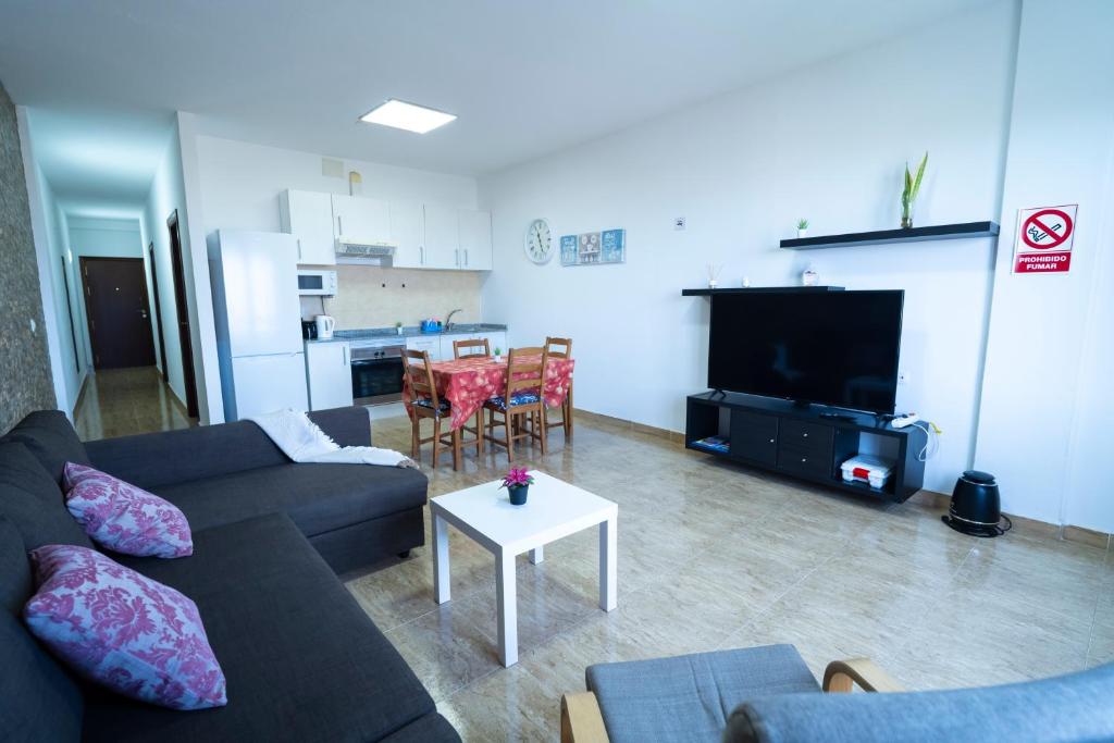 a living room with a couch and a table at Edificio Prieto Vivienda 2D in Puerto del Rosario