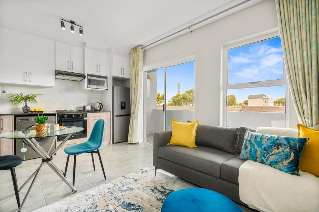 a living room with a couch and a table at The Orion 16 in Table View