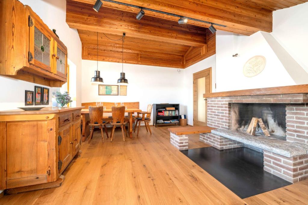 a kitchen and living room with a brick fireplace at Ferienwohnung Dorfmitte in Reit im Winkl