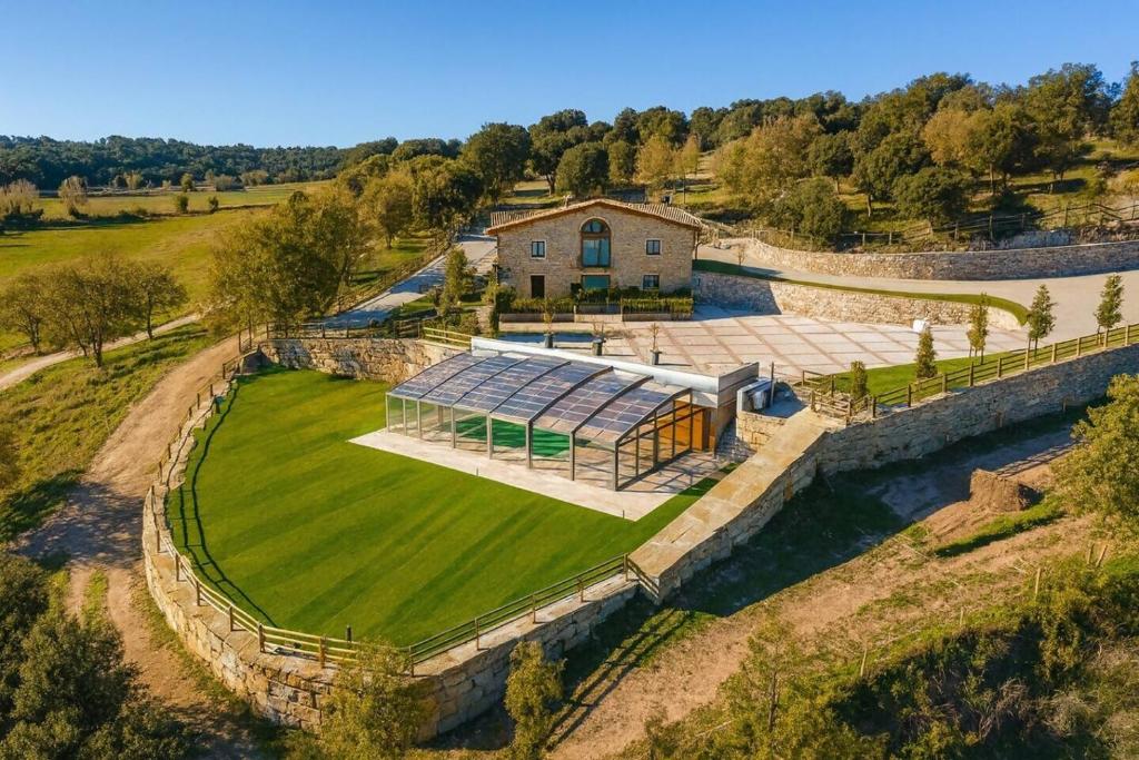 an aerial view of a house with a solarium at Villa Mas Summit in Collsuspina