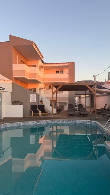 a large swimming pool in front of a house at Coralli Beach Hotel in Kokkini Khanion