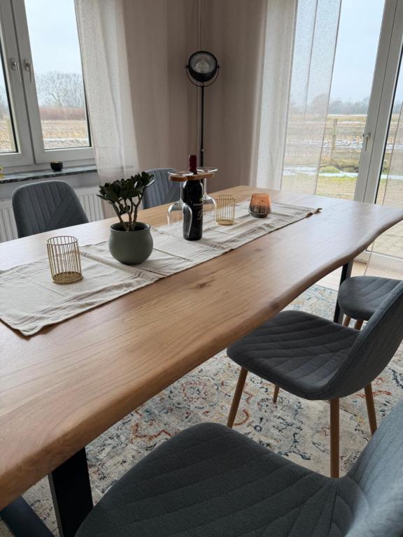 a wooden table with two chairs and a table with at Ferienhaus Arlewatt in Arlewatt