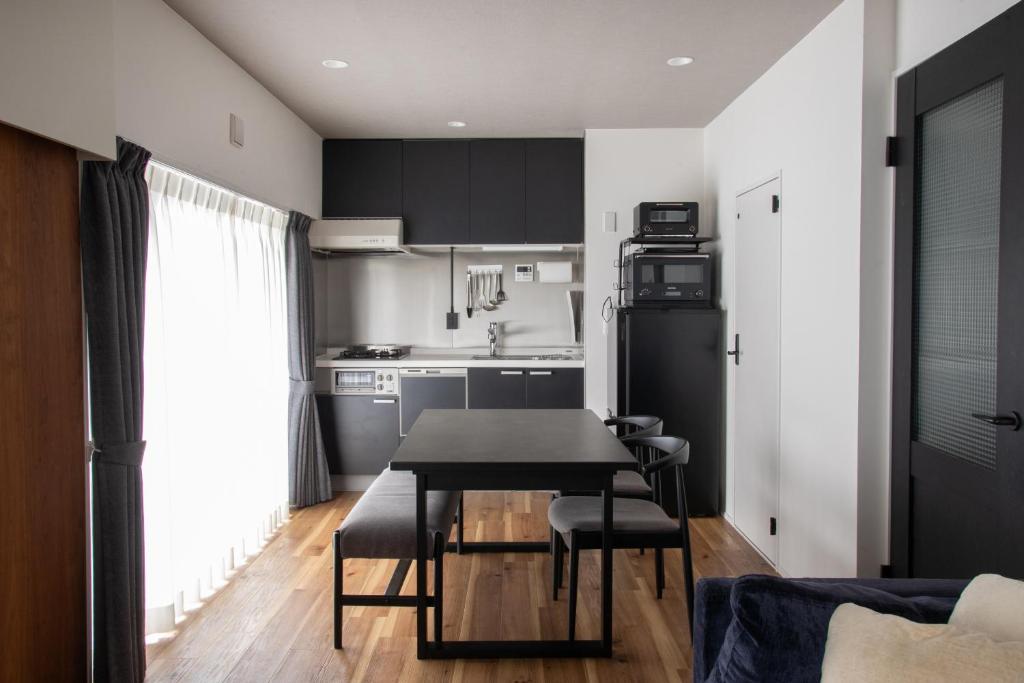 a kitchen and dining room with a table and chairs at NIYS apartments 56type in Tokyo