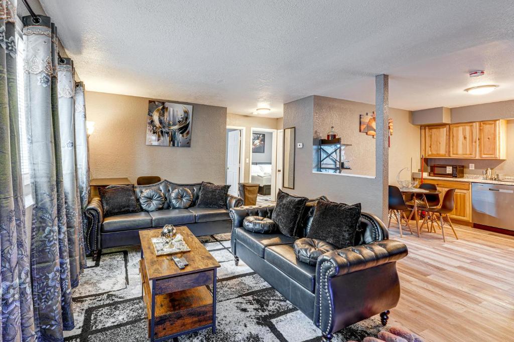 a living room with two couches and a kitchen at Easily Explore Anchorage! Modern Duplex Near Town in Alaska Regional Hospital Heliport