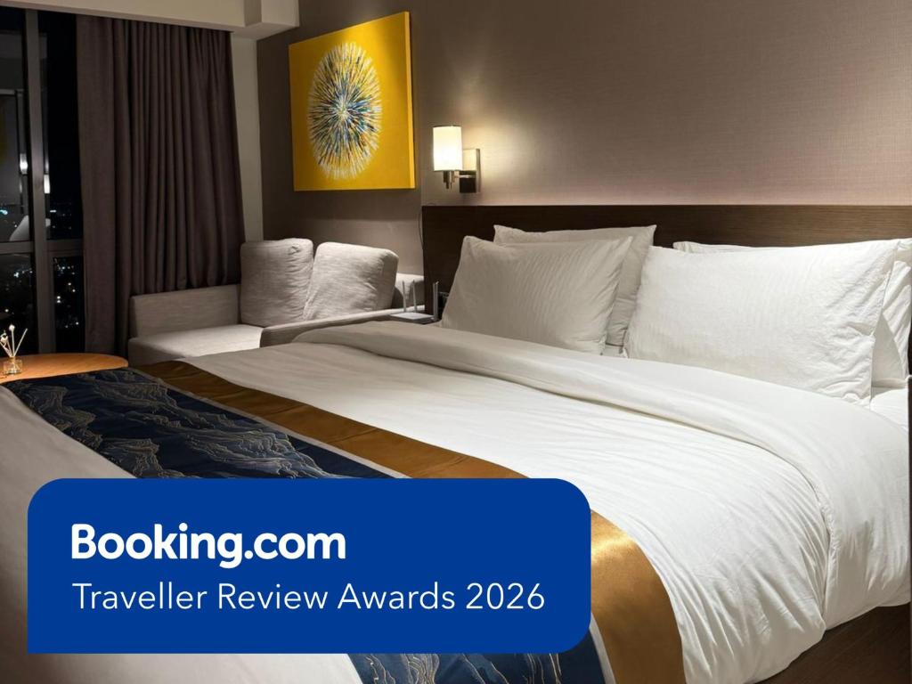 a hotel room with a large bed with white sheets at Novotel Suites Celestia at Hotel Residences Manila in Manila