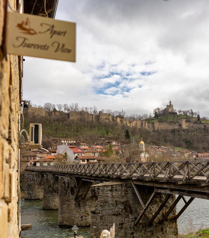 a bridge over a river with a town in the background at Apart Tsarevets View - Free PARKING in Veliko Tŭrnovo