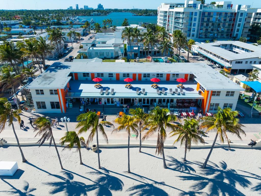 an aerial view of a hotel on the beach with palm trees at La Terrace Oceanfront in Hollywood