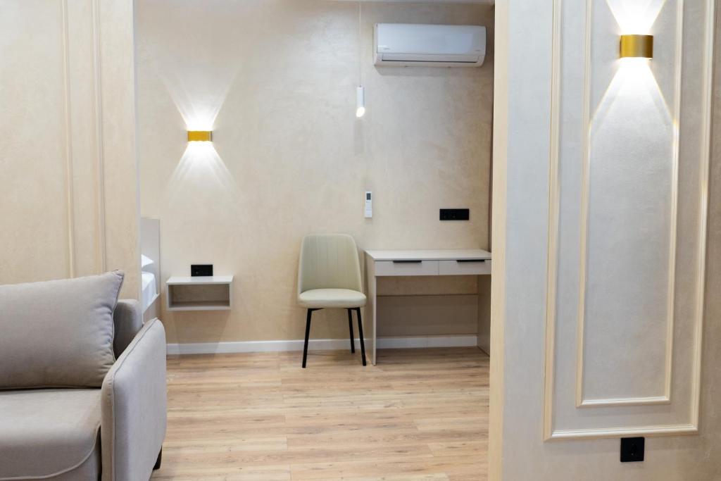 a waiting room with a chair and a desk at Мегаполис in Astana
