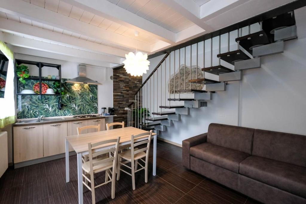 a kitchen and dining room with a table and a couch at Lake-Hot Springs-Gardaland, Private Parking at Dolce Duplex Lazise in Lazise