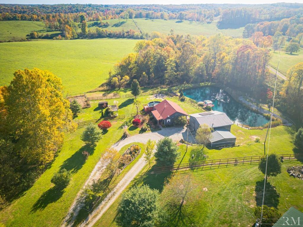 an aerial view of a house in the middle of a field at Sunset Cottage Hocking Hills in Rockbridge