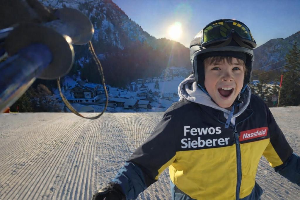 a young boy with his mouth open in the snow at Fewo's Sieberer in Kirchbach