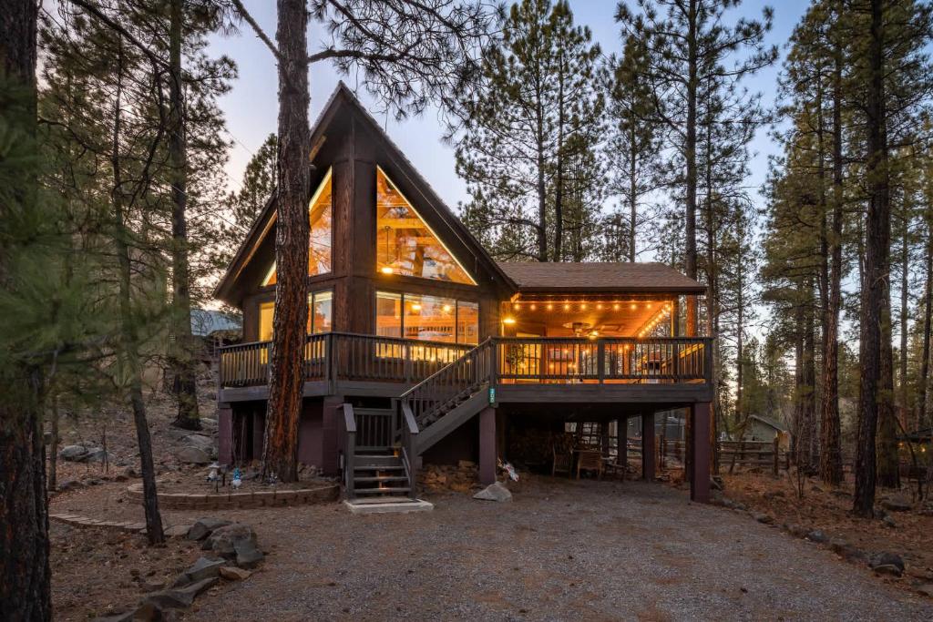 a cabin in the woods with a wrap around deck at Cozy Chalet in the Pines in Munds Park