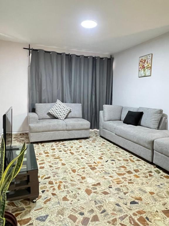 a living room with two couches and a rug at Casa Altamirano in Chilpancingo de los Bravos