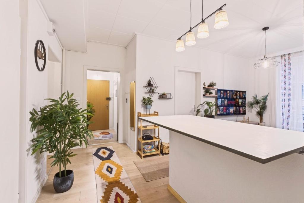 a kitchen with a large white counter in a room at Bistro Walk Apartment in Lausanne