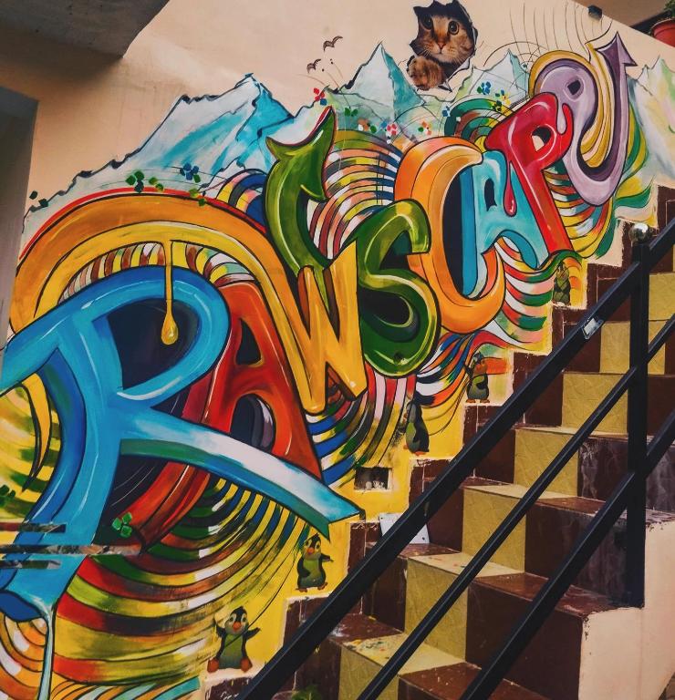 a mural of the word music on a wall at The Rawscape Hostel in Kausani