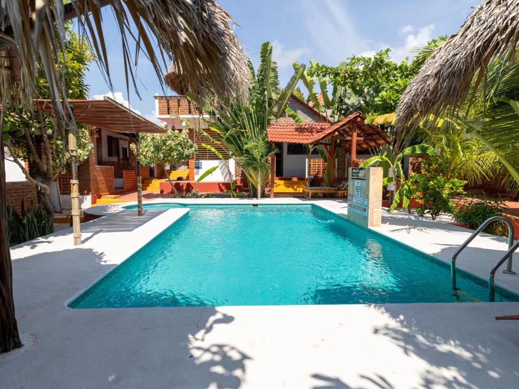 a swimming pool in front of a house at Las Barracas de la Barra in Malucano