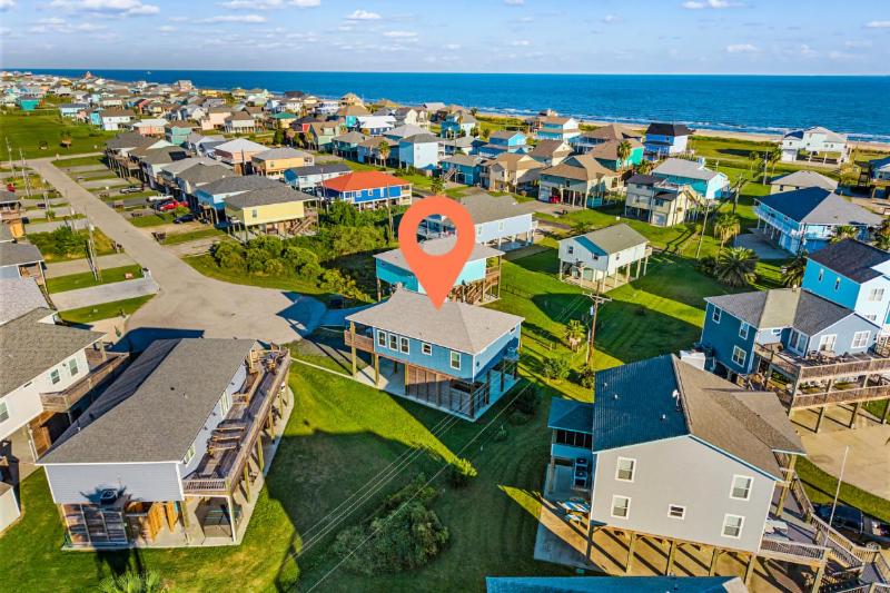 an aerial view of a residential neighborhood with a red marker at Steps to the Beach l Modern Interior in Crystal Beach