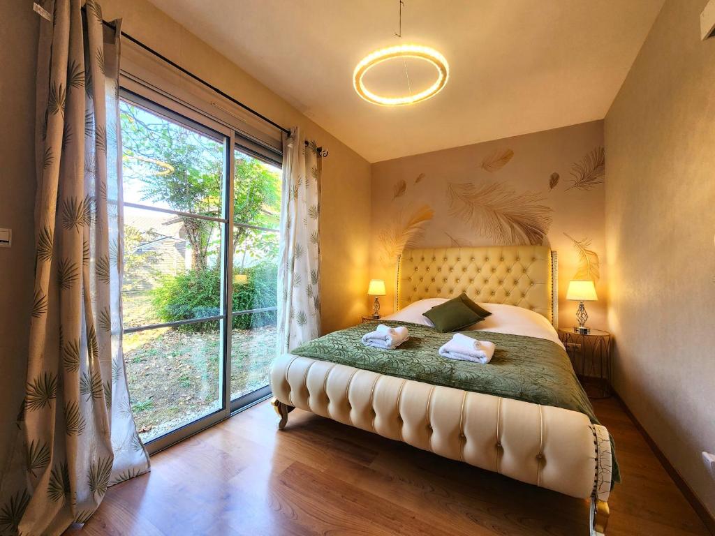 a bedroom with a bed and a large window at Symphony - in Saint-Emilion in Saint-Émilion