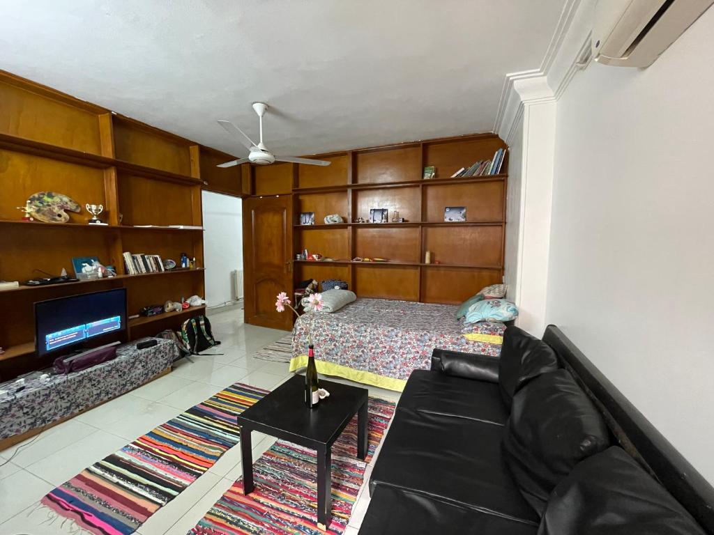 a living room with a couch and a bed at Cozy Private Room with Jacuzzi Maadi in Cairo