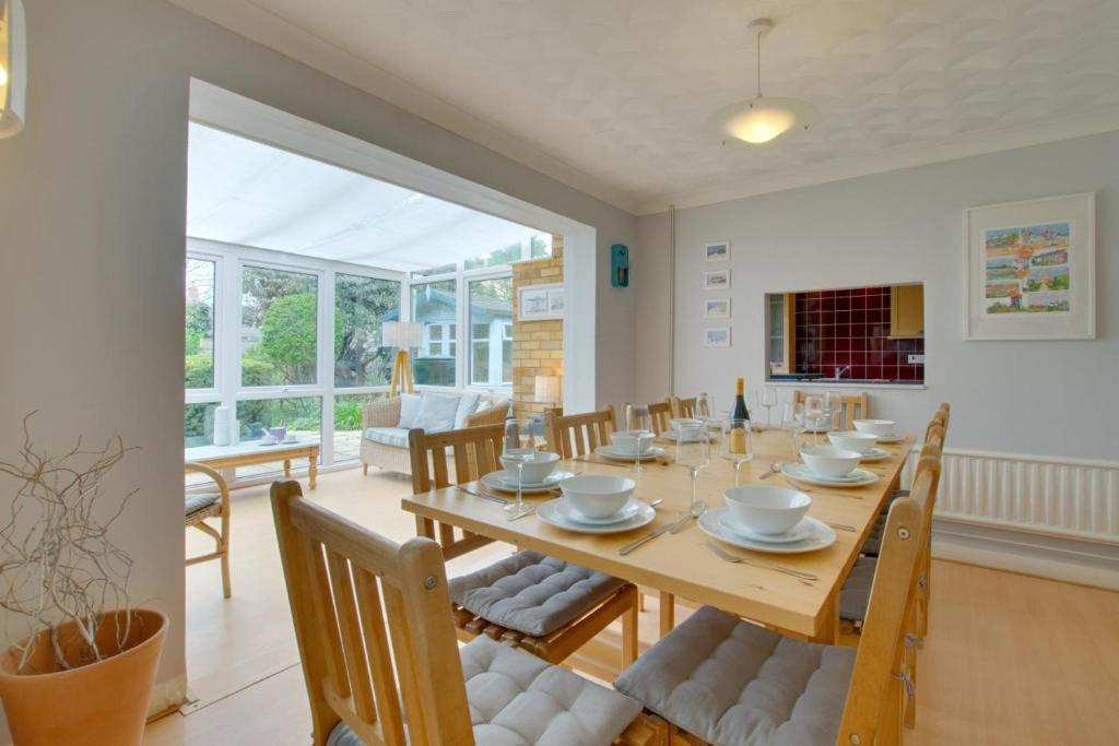a dining room with a wooden table and chairs at 4 Bed in Reydon oc-fll in Reydon