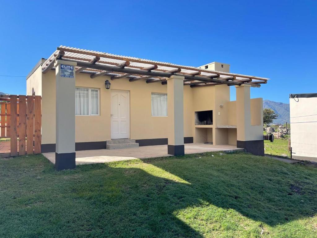 a small house with a porch and a gate at Casas 7 Cabritas in Tafí del Valle
