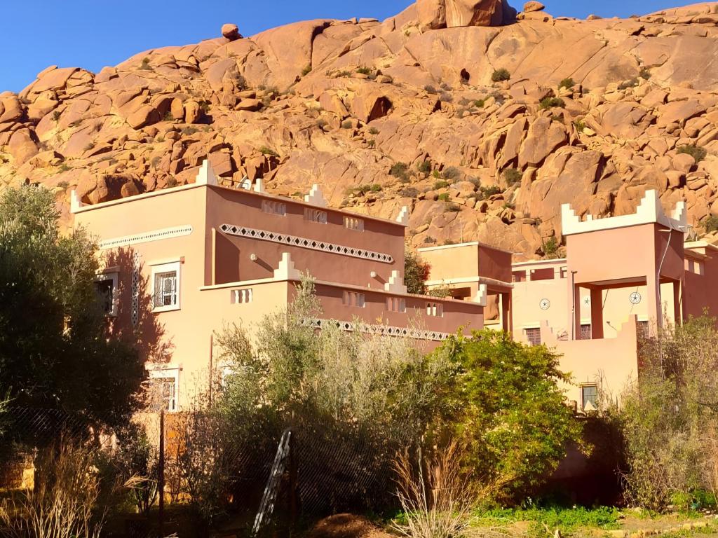 a building in front of a mountain at Guest house wakrim in Tafraout