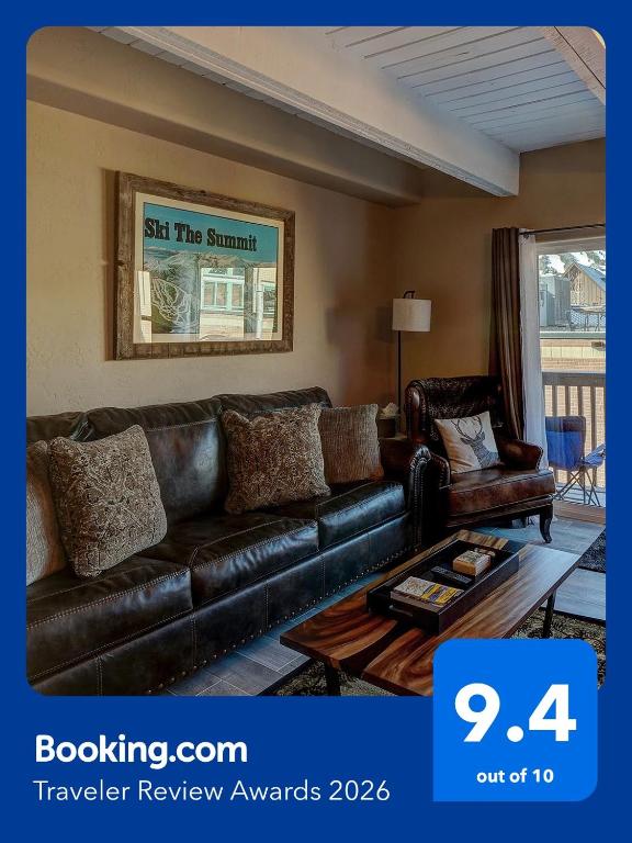 a living room with a leather couch and a coffee table at Main Street Breck, Walk Everywhere! in Breckenridge