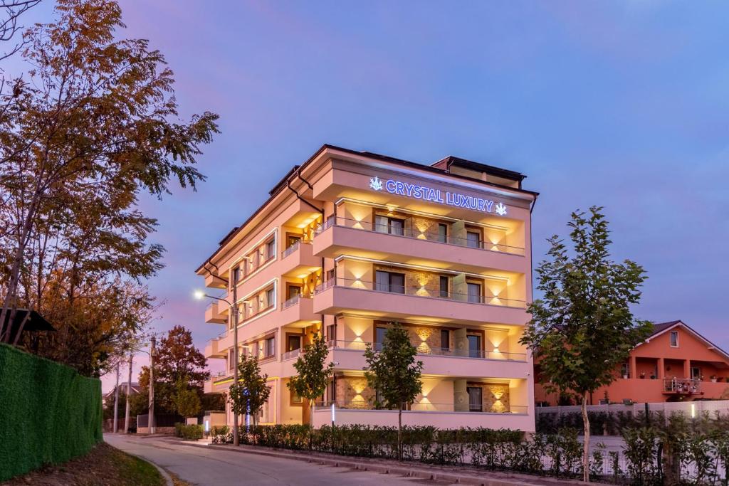 a building with a sign on the side of it at Crystal Luxury in Craiova
