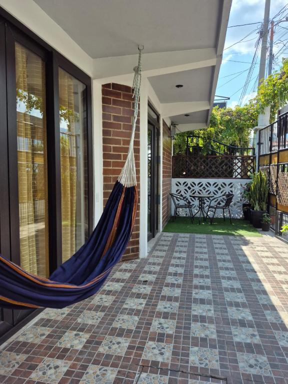 a hammock on the front porch of a house at Home Garden in San Pedro La Laguna