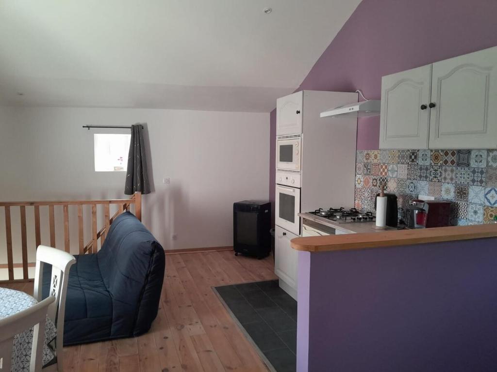 a kitchen with a stove and a counter top at 35 m2 independent studio in Marillet