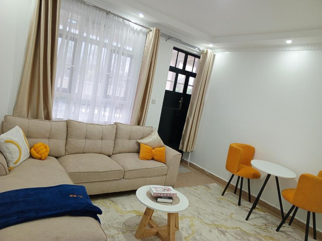 a living room with a couch and a table at Wema m stays in Munyu